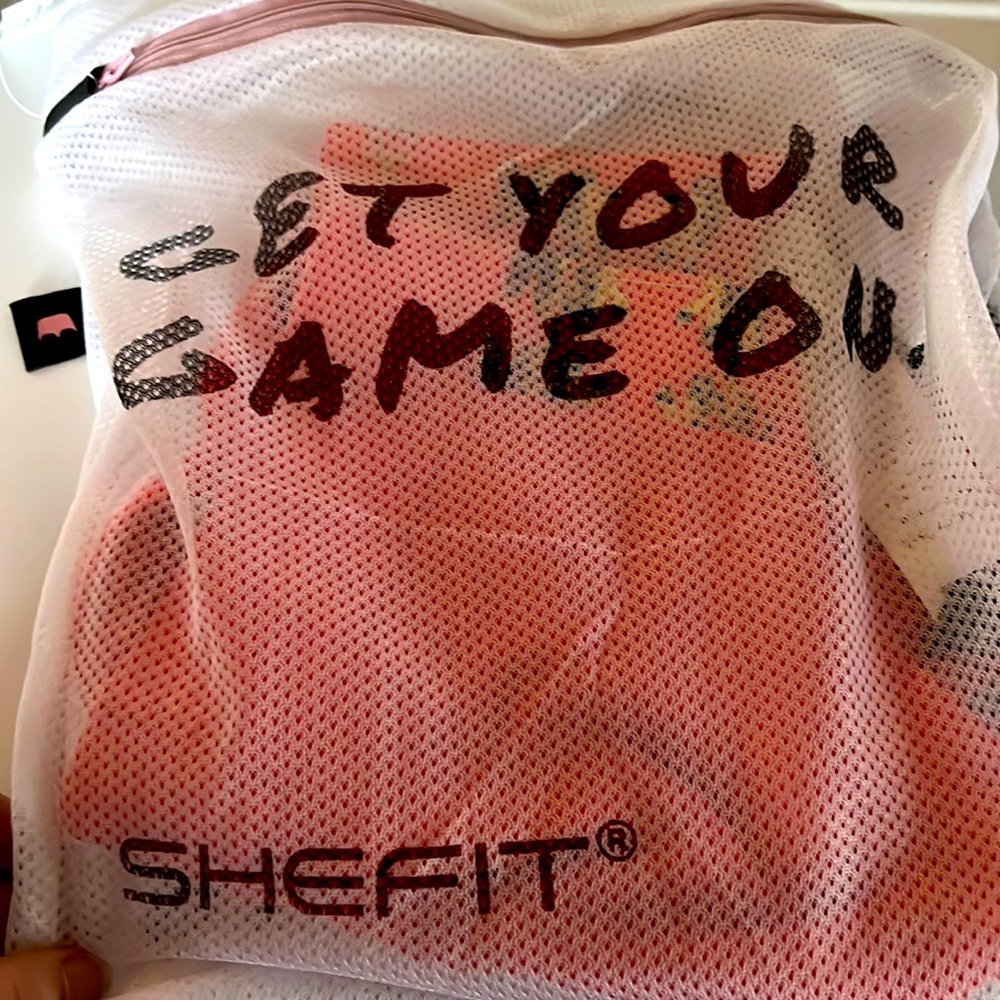 SheFit coral sports bra
